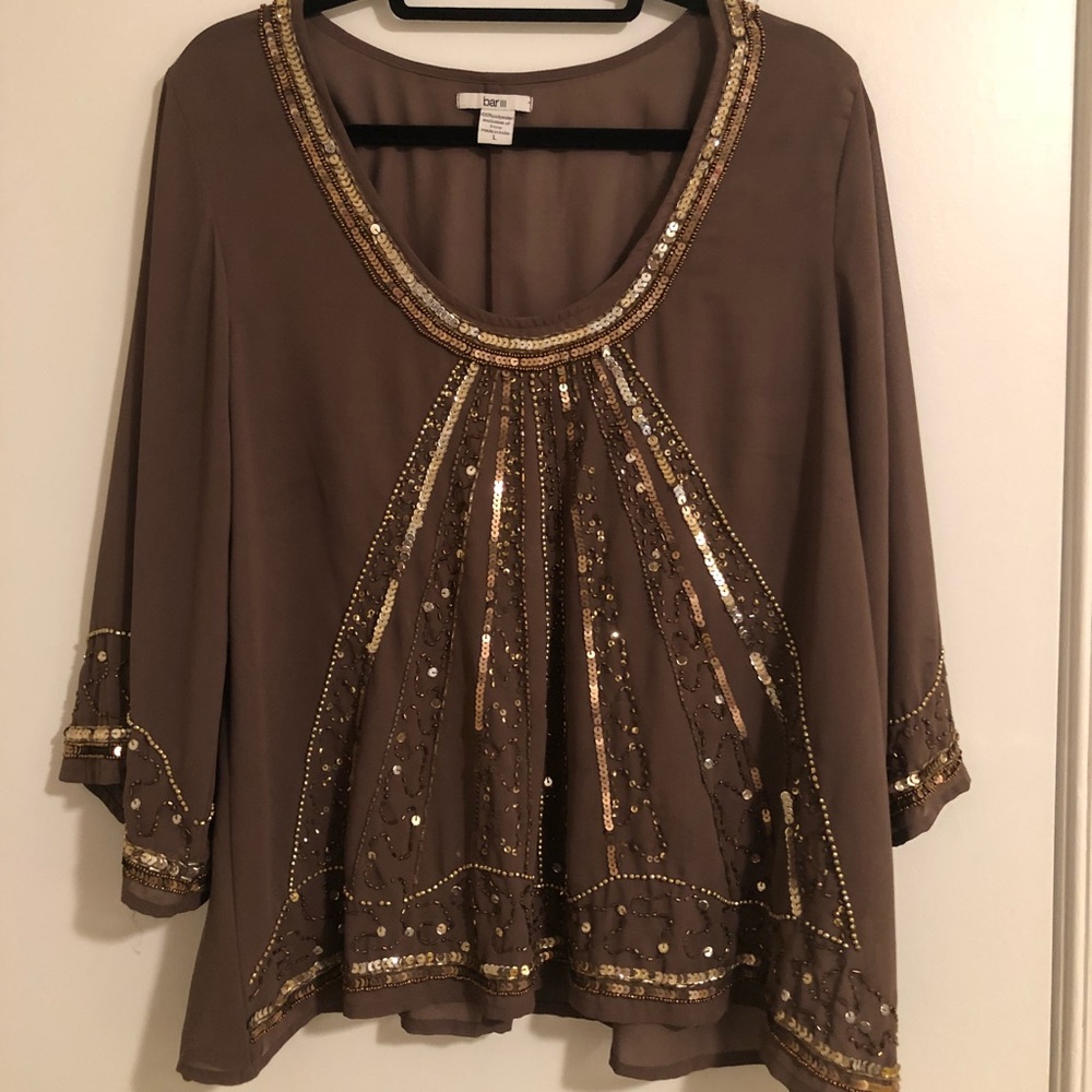 Light sheer plum top with gold detailing.